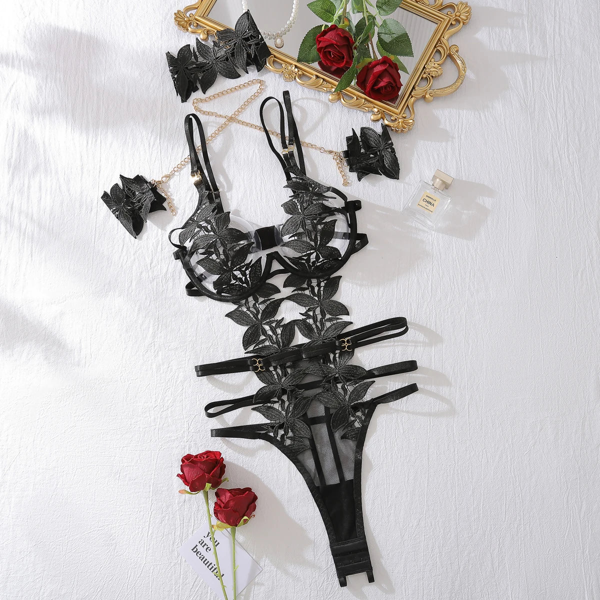 Bodysuit with lace appliqués and multiple straps